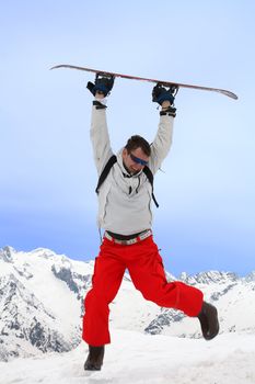 Men jumps with snowboard in two hands