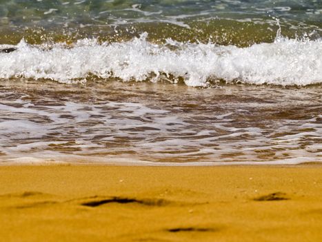 Waves crashing on the coast on a beach in Malta