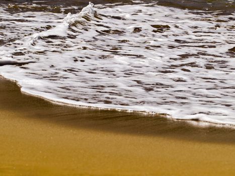 Waves crashing on the coast on a beach in Malta