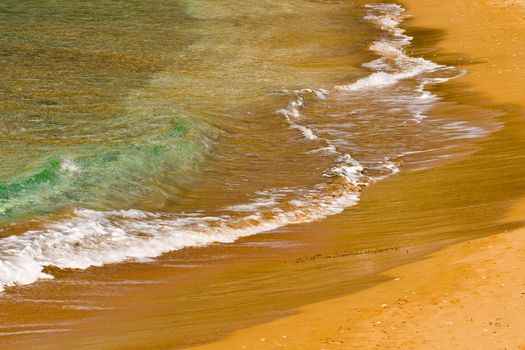 Waves crashing on the coast on a beach in Malta