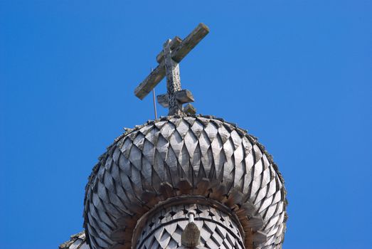 Dome on turn blue firmament.The Old-time wooden church. Ancient architecture