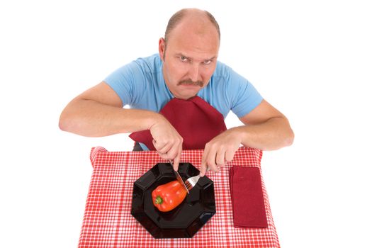 Mature man looking very annoyed having to eat those vegetables