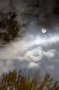 image of the moon in the sky hidden by the clouds