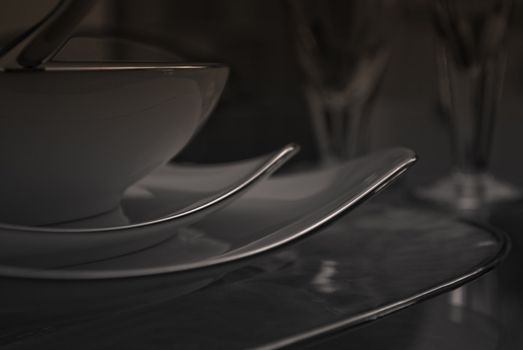 modern dishes and glasses on a glass table