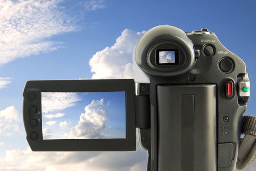 A videocamera filming blue sky