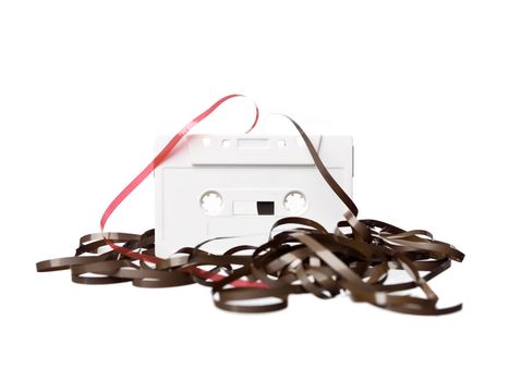 Broken audio cassette isolated on a white background