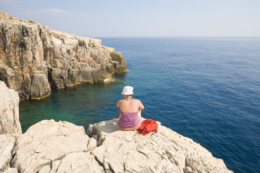 young girl sitting on the rock - Croatian coast