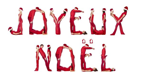 Elfs forming the phrase 'Joyeux Noel' isolated on white
