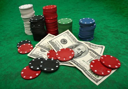 Gambling chips and dollar bills over green felt. I�ve got more poker images