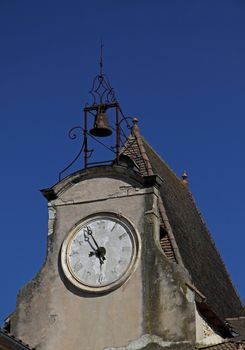 Damaged clock face on an abandoned schoolhouse in SW France