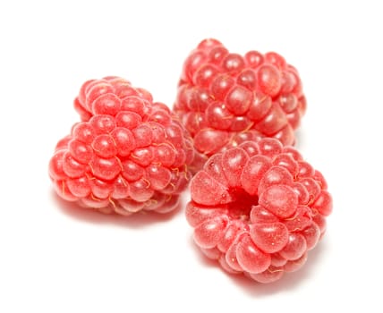 close-up three ripe raspberries, isolated on white