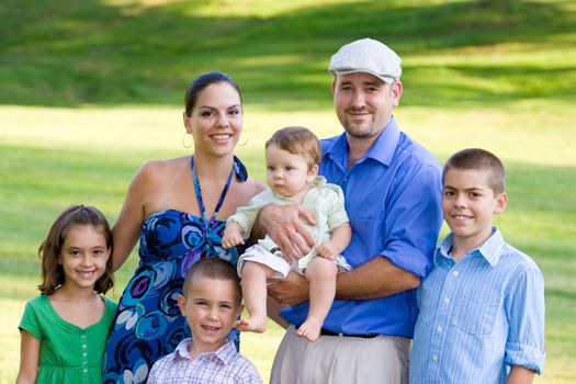 Portrait of an attractive young family with four children.