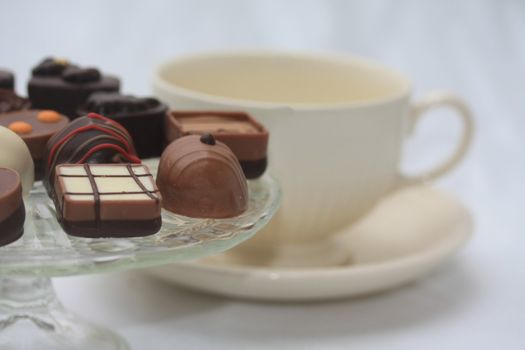 Assorted belgium chocolates and a tea cup