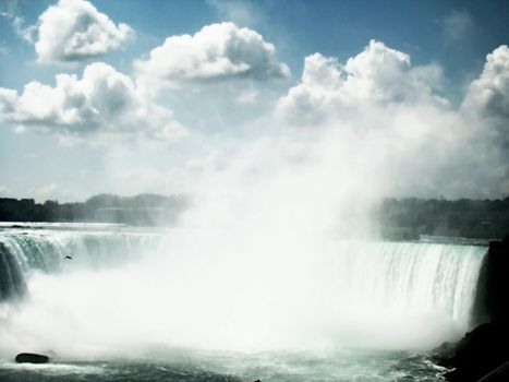 mist flows upwards from the force of the water on Niagara Falls