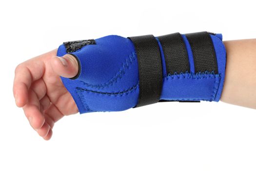 Human hand with a wrist brace, orthopeadic equipment over white