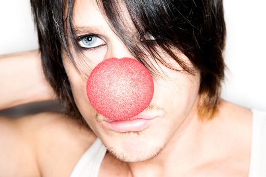 Handsome young male model with clown nose