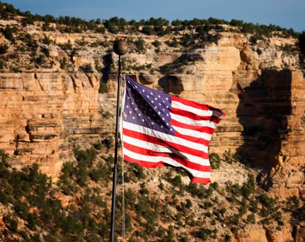 Fluttering American Flag in front of Grand Canyon Ridge