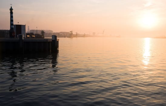 View on river and harbor with morning fog after sunrise