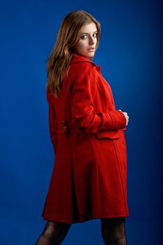 Portrait of a beautiful and sexy young model posing with a red jacket