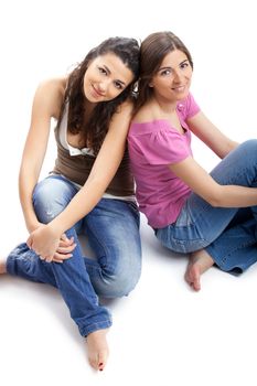 Two beautiful and happy young women isolated over white background