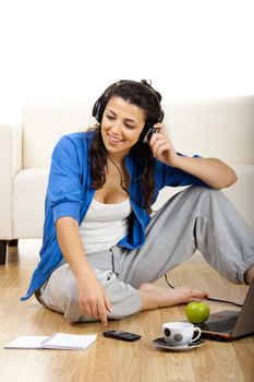 
Portrait of a girl seated on floor calling on phone