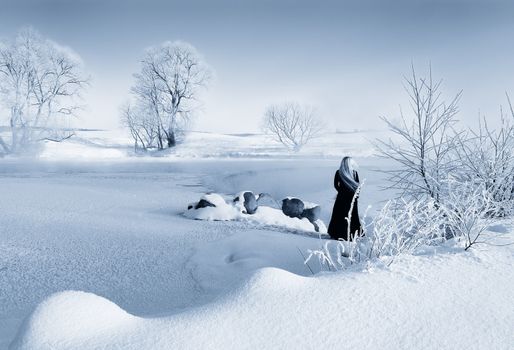 Frosty winter morning in Belarus, the girl about the frozen reservoir.