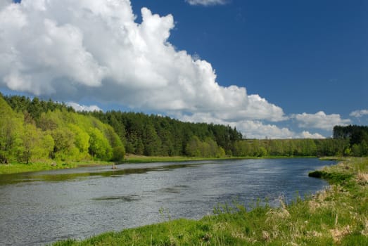 Clouds in the sky over the river Vilija in the spring afternoon.