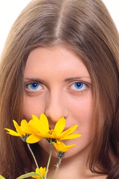The nice girl with a yellow flower and dark blue eyes removed close up