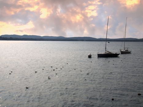 Landscape of a lake with mountains and a sail