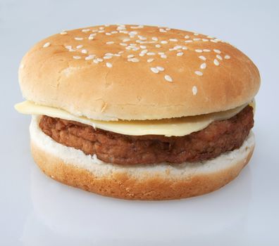 Isolated cheeseburger over a gray/white background