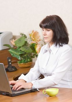 Serious businesswoman working on her laptop 