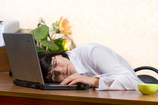 Tired businesswoman sleeping on the desk