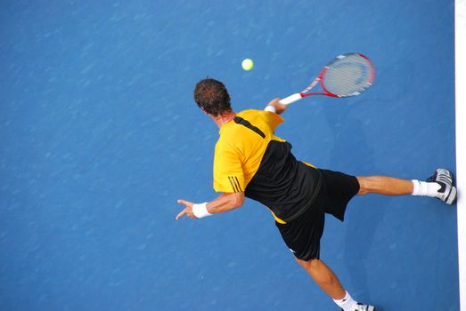 A tennis player getting ready to return a serve