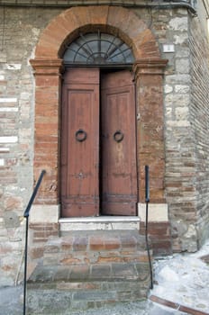 Wooden door with a stone door frame - Open - Tuscany - Italy