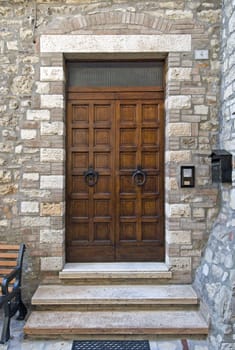 Wooden door with a stone door frame - Tuscany - Italy