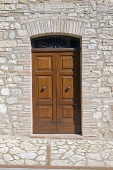 Wooden door with a stone door frame - Tuscany - Italy