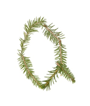 Spruce twigs forming the letter 'Q' isolated on white