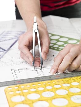 Male architect working on a bluprint, close up on hand and bluprint.