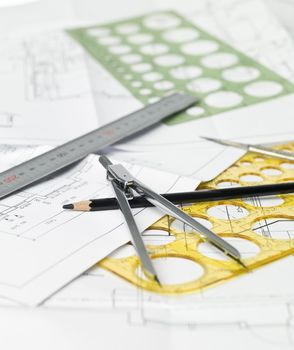 Drawing compass, pen and ruler on blueprints