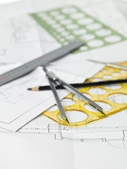 Drawing compass, pen and ruler on blueprints