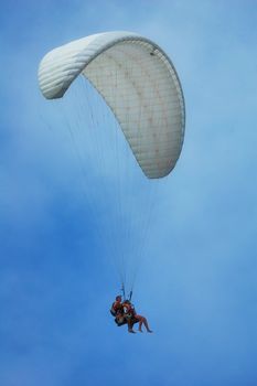 flights on a parachute by a clear summer day