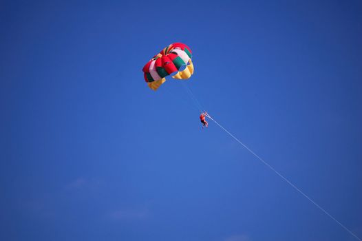 flights on a parachute by a clear summer day