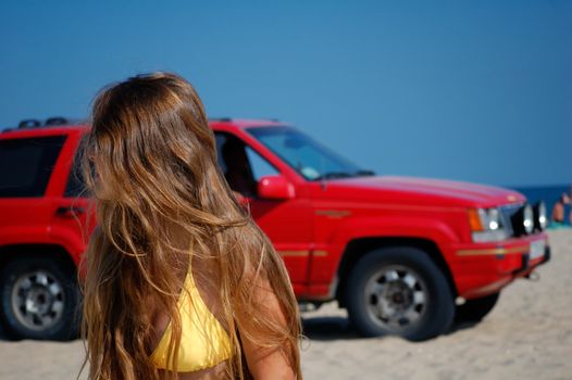 girl in a clear summer day on a marine beach