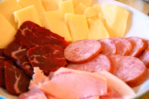 An appetizer plate of meat and cheese
