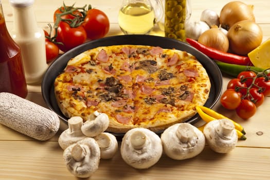 A couple of delicious pizzas, with raw tomatoes, green peppers and mushrooms