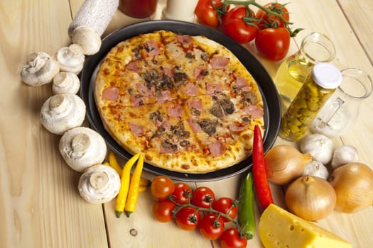 A couple of delicious pizzas, with raw tomatoes, green peppers and mushrooms