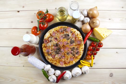 A couple of delicious pizzas, with raw tomatoes, green peppers and mushrooms