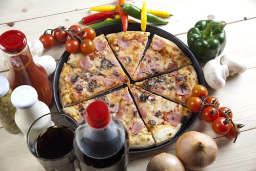 A couple of delicious pizzas, with raw tomatoes, green peppers and mushrooms