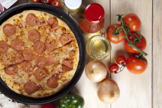 A couple of delicious pizzas, with raw tomatoes, green peppers and salami