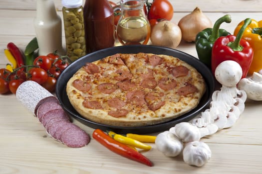 A couple of delicious pizzas, with raw tomatoes, green peppers and salami